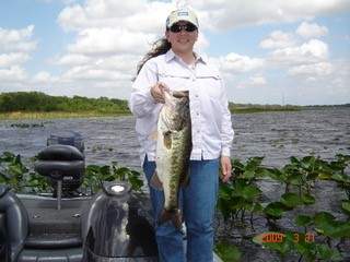 A lady holding her lunker bass